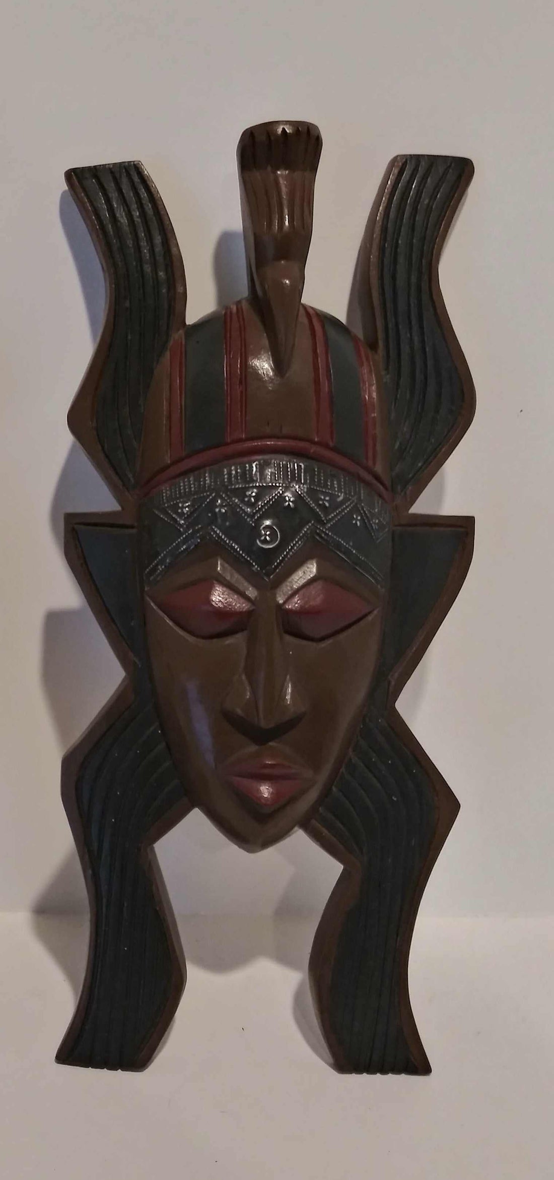 African handcrafted mask with intricate tribal patterns and traditional wood carving