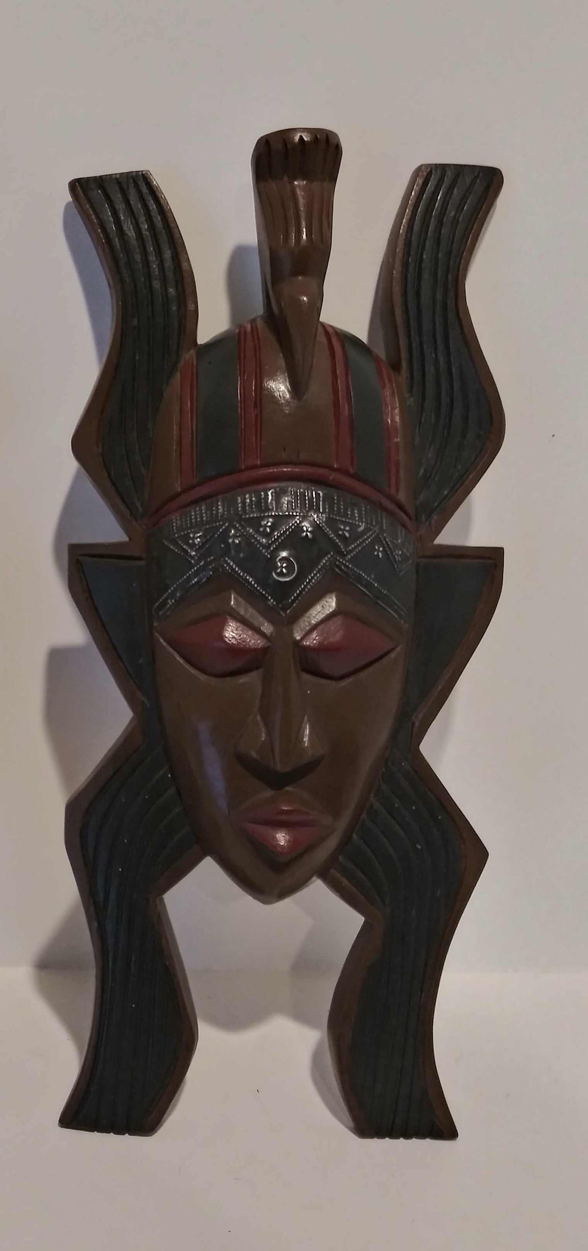 African handcrafted mask with intricate tribal patterns and traditional wood carving