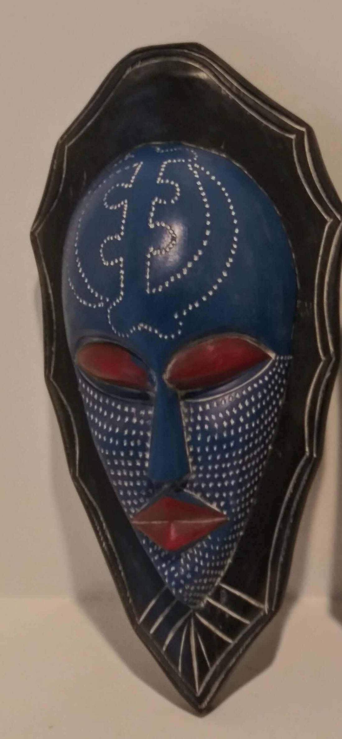 Handcrafted African wall mask with traditional tribal patterns and rich cultural symbolism