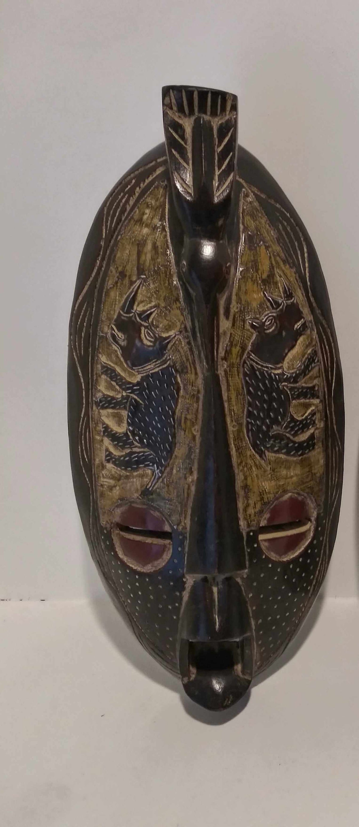 Handcrafted African-inspired long wall mask with tribal patterns, elegant home decor.