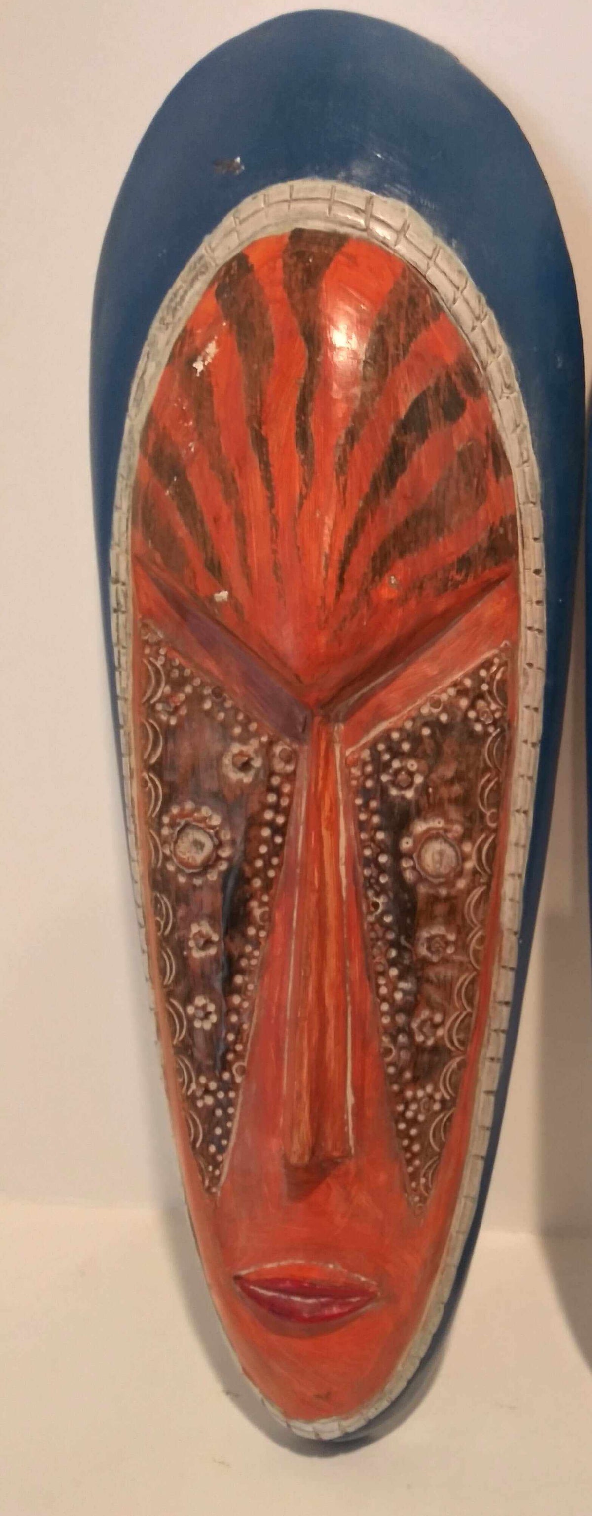 Authentic African tribal mask handcrafted with vibrant colors and intricate patterns showcasing cultural heritage.