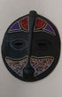 Round colorful wall mask with intricate patterns and vibrant colors for decorative wall art