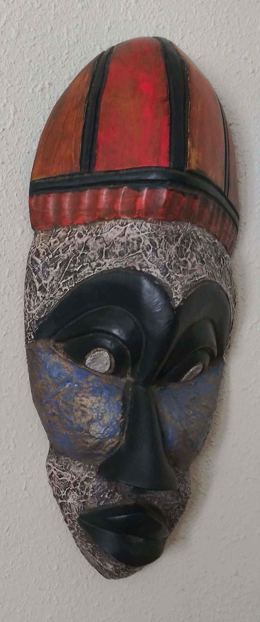 unique mask decorations featuring a handcrafted African mask with vibrant colors and intricate design details.