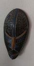 Handcrafted African tribal mask with intricate carved patterns and bold design representing cultural heritage and tradition